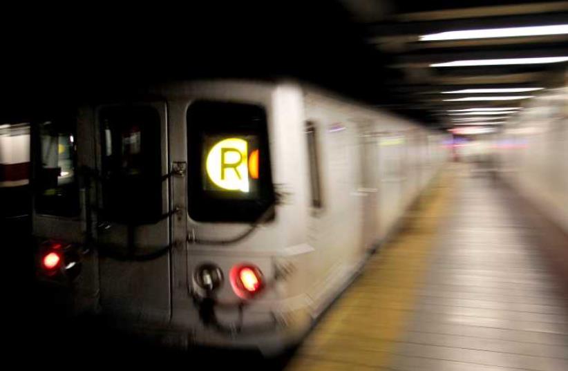 A Metropolitan Transit Authority (MTA) R-train streaks through the Canal Street subway station in downtown New York (photo credit: REUTERS)