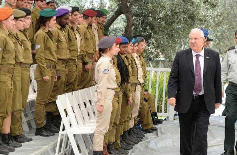 PRESIDENT REUVEN RIVLIN reviews this year’s 120 outstanding soldiers during a practice session at his Jerusalem residence yesterday in advance of Independence Day. (photo credit: GPO)