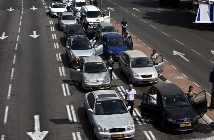 Traffic comes to a standstill as siren sounds on Israel's Remembrance Day‏. (photo credit: REUTERS)