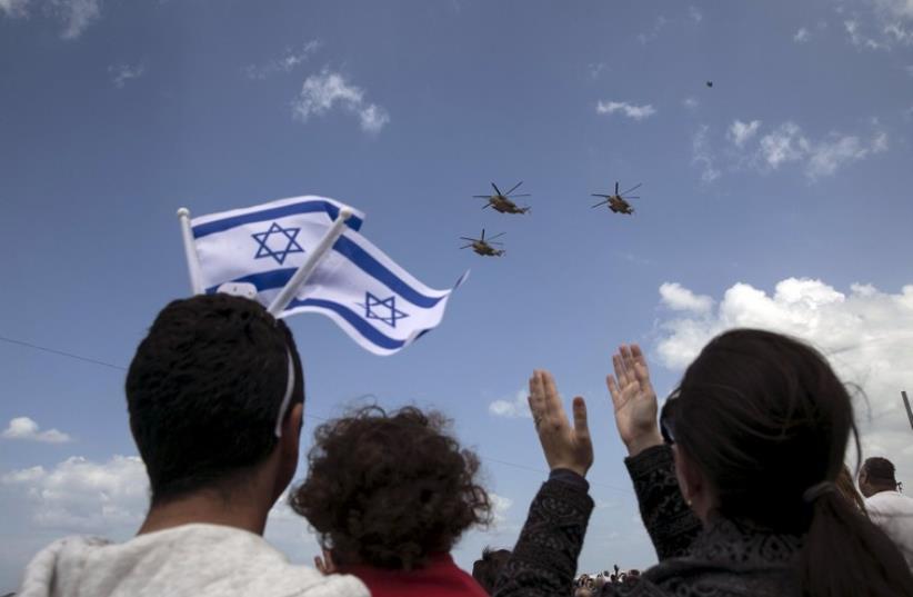 IAF planes fly during an aerial show over the Mediterranean Sea as seen from a Tel Aviv beach, as part of Independence Day celebrations, April 23, 2015 (photo credit: REUTERS)