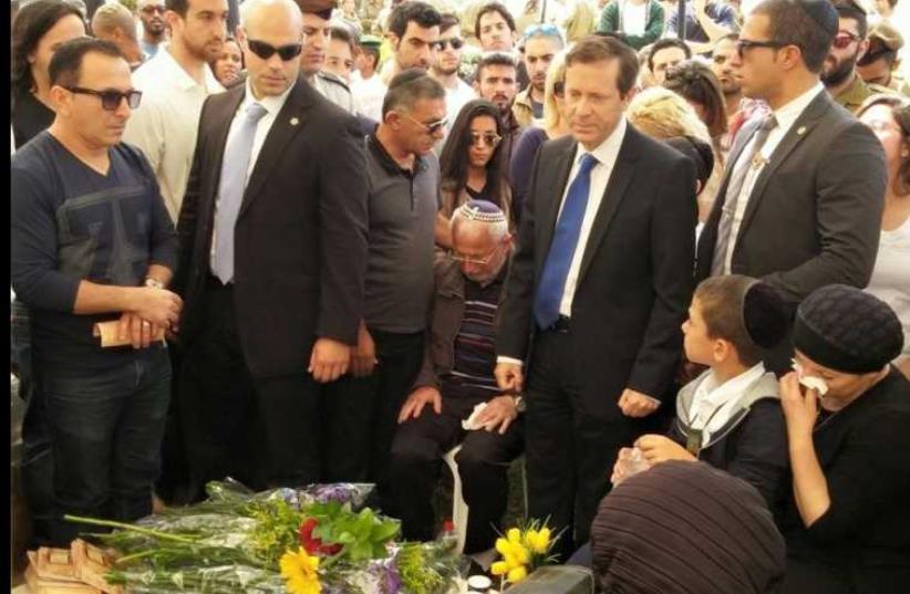 Zionist Union leader Isaac Herzog pays his respects to the fallen at the military cemetery in Ashkelon (photo credit: FACEBOOK)