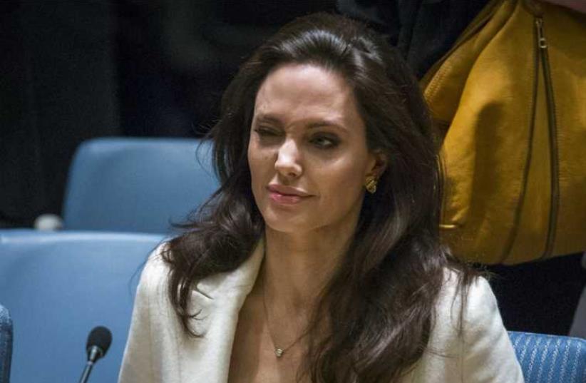 United Nations High Commissioner for Refugees special envoy, actress Angelina Jolie, winks as she arrives to speak during a Security Council meeting regarding the refugee crisis in Syria (photo credit: REUTERS)
