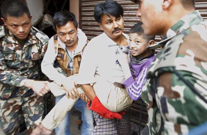Boy rescued from collapsed house after Nepal earthquake  (photo credit: REUTERS)