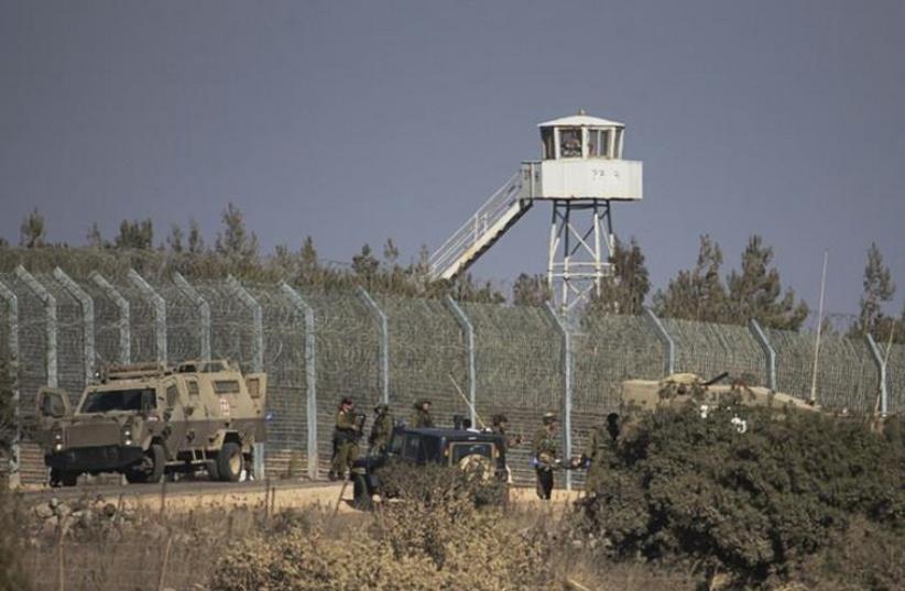 Israeli soldiers stand near the border with Syria in the Golan Heights (photo credit: REUTERS)