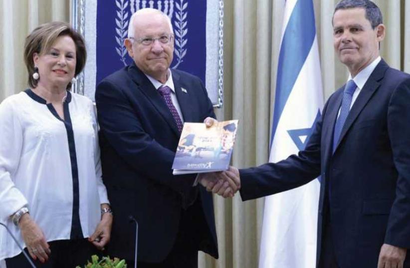 PRESIDENT REUVEN Rivlin receives the Elem report yesterday at the President’s Residence from Shlomo Yanai and Nava Barak (photo credit: Mark Neiman/GPO)