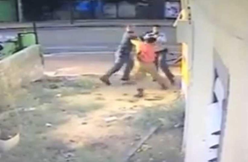 Screenshot of video showing police officer attacking IDF soldier‏. (photo credit: screenshot)