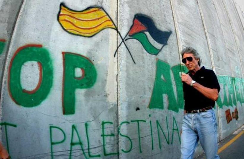 British rock star Roger Waters of Pink Floyd walks along the controversial Israeli barrier in the West Bank city of Bethlehem June 21, 2006. (photo credit: REUTERS)