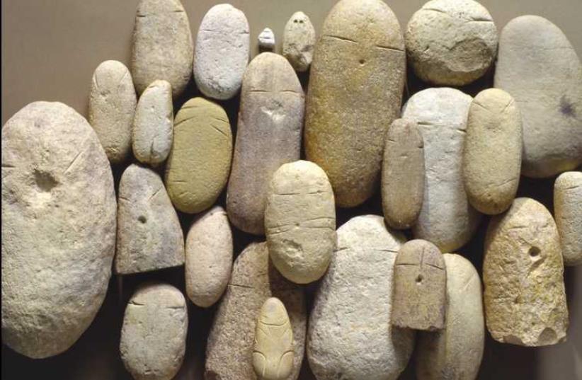 Brief History of Humankind: Pebble figurines, Sha'ar Hagolan and Munhata, Jordan Valley, 8000 years old. (photo credit: IAA)