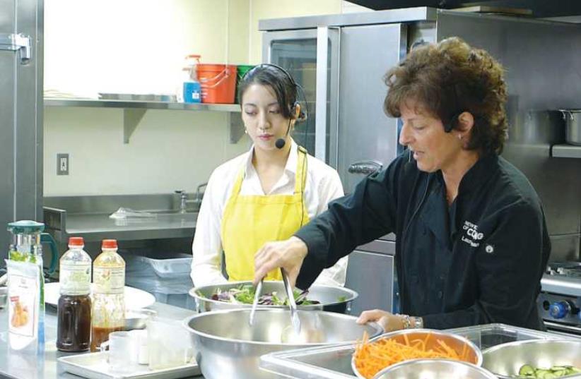Chef Laura Weinman making glazed salmon salad; with Valerie Hwang. (photo credit: YAKIR LEVY)