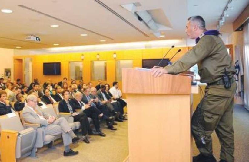 COL. GRISHA YAKUBOVICH of COGAT briefs foreign ambassadors on the humanitarian situation in Gaza during the war last summer. (photo credit: FOREIGN MINISTRY)