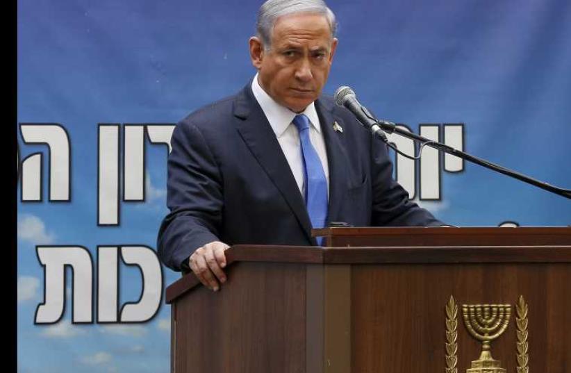 Prime Minister Benjamin Netanyahu speaks during a Memorial Day ceremony on Mount Herzl military cemetery in Jerusalem (photo credit: REUTERS)