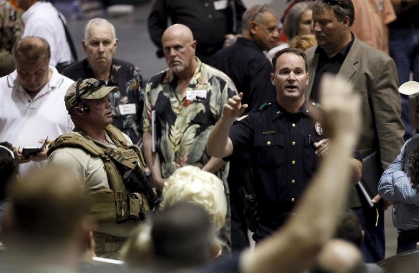  A police officer seeks witnesses to the shooting outside of the Muhammad Art Exhibit and Contest sponsored by the American Freedom Defense Initiative in Garland, Texas (photo credit: REUTERS)