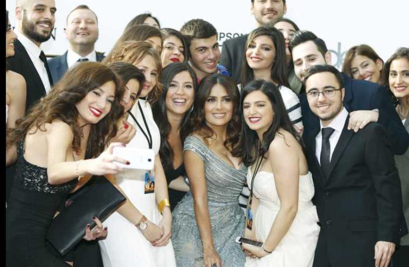Actress Salma Hayek (front, third from right) poses with her fans ahead of the screening of her film ‘The Prophet’ in Beirut on April 27. (photo credit: REUTERS/MOHAMED AZAKIR)