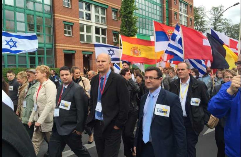 Knesset Christian Allies Caucus director Josh Reinstein marches with March of Life founder Jobst Bittner and caucus head MK Robert Ilatov (l-r) at the Berlin March of Life (photo credit: ISRAEL ALLIES FOUNDATION)