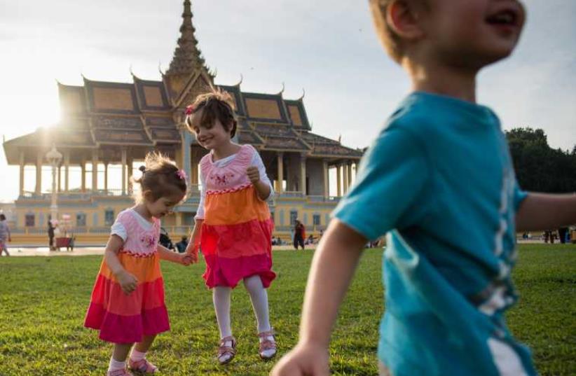 Three of Butman’s five children, Henya, Mushka, and Shmulik, cavort at the Royal Palace in Phnom Penh. (photo credit: ANNA CLARE SPELMAN)