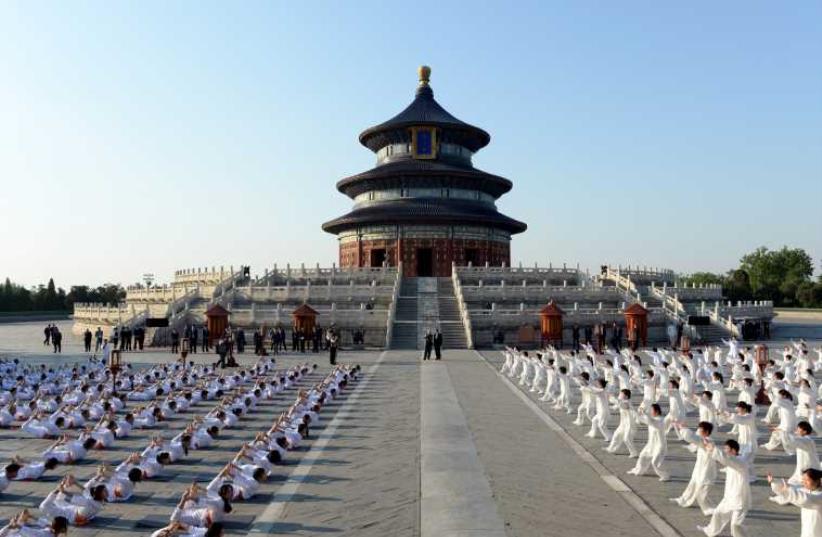 Indian Prime Minister Narendra Modi and Chinese Premier Li Keqiang attend the Taiji and Yoga event at the Temple of Heaven park in Beijing, China on May 15 (photo credit: REUTERS)