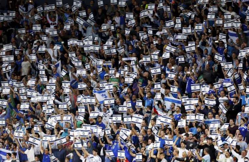 Israel fans hold placards during their Euro 2016 Group B qualifying soccer match against Wales at the Sammy Ofer Stadium in Haifa (photo credit: REUTERS)