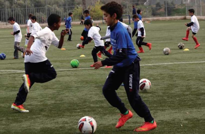 Children playing soccer (file) (photo credit: COURTESY NEW ISRAEL FUND)