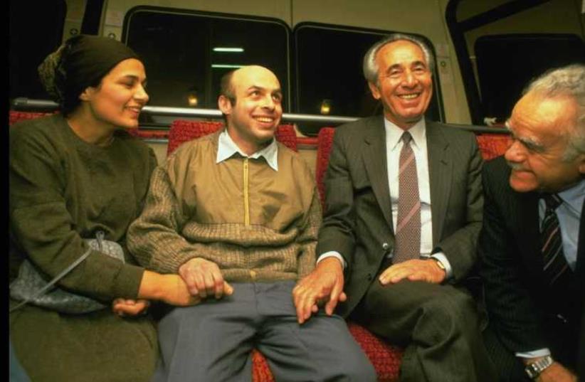 Natan Sharansky (second left) is met upon arriving at Ben-Gurion Airport in November 1986 by his wife, Avital, then-prime minister Yitzhak Shamir (right) and then-deputy prime minister Shimon Peres. (photo credit: GPO)