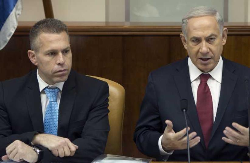 Gilad Erdan and Benjamin Netanyahu (photo credit: MENAHEM KAHANA / AFP)