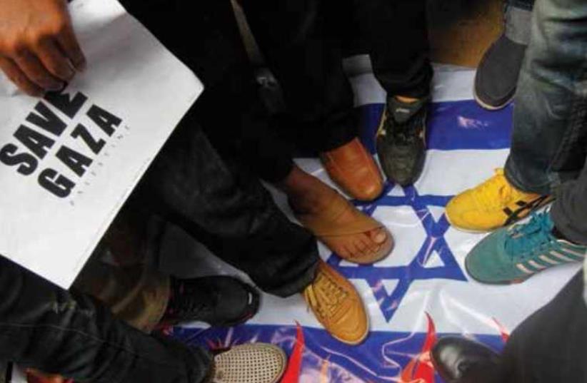 Demonstrators step on the national flag during an anti-Israel protest in front of the Israeli Embassy in Bangkok last year. (photo credit: Wikimedia Commons)