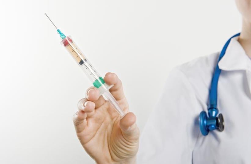 Vaccine syringe (photo credit: INGIMAGE)