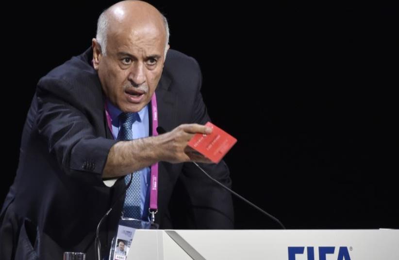 President of the Palestinian FA Jibril Rajoub shows a red card as he speaks during the 65th FIFA Congress on May 29, 2015 in Zurich. (photo credit: AFP/MICHAEL BUHOLZER)