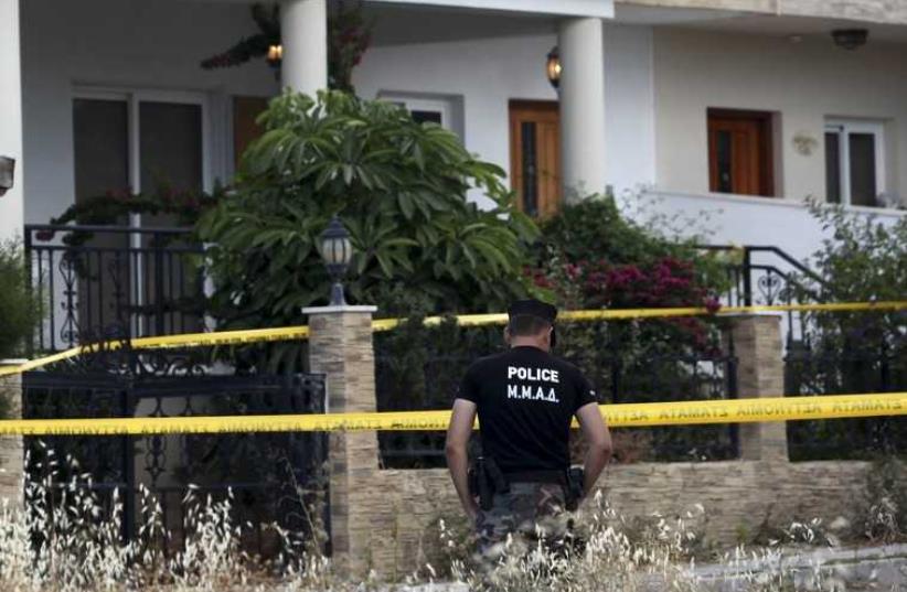 A policeman stands guard at a house where police discovered almost two tonnes of ammonium nitrate, in Larnaca, Cyprus, May 29 (photo credit: REUTERS)