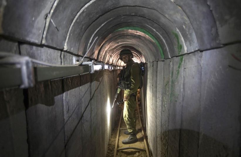 An Israeli army officer during an army organized tour for journalists in a tunnel said to be used by Palestinian terrorists for cross-border attacks (photo credit: REUTERS)
