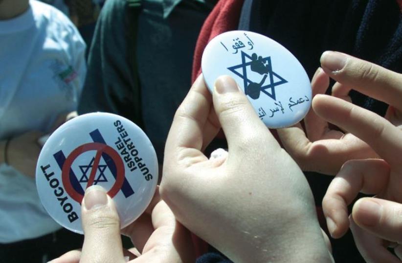 WOMEN HOLD pins that advocate a boycott against Israel (photo credit: REUTERS)