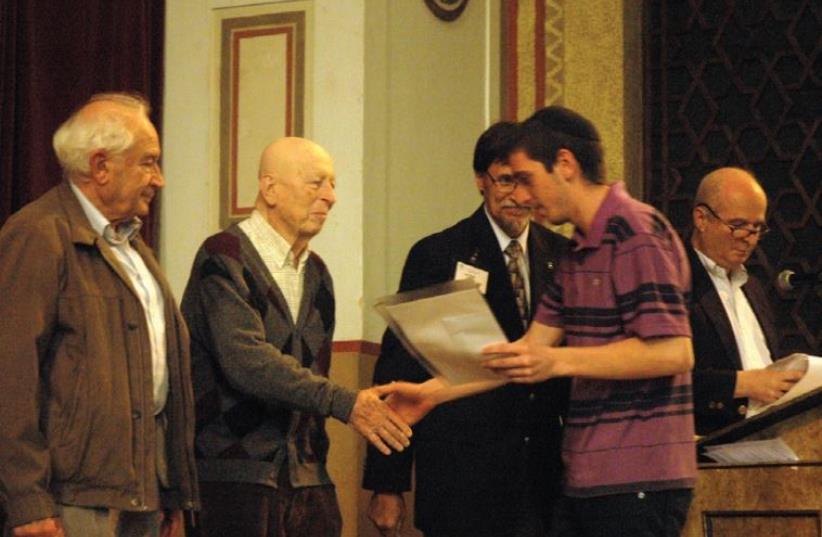 A high-school student receives an award from the Jerusalem Rotary Club. (photo credit: Courtesy)