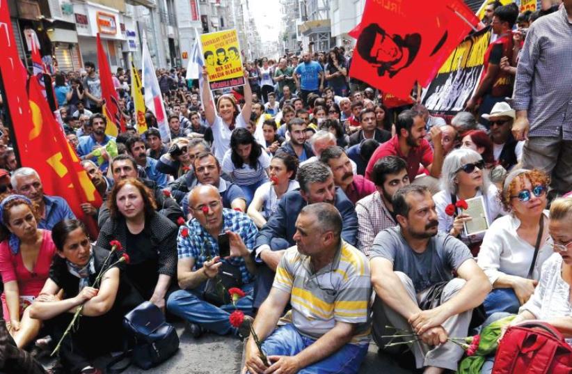 Demonstrators, with a banner reading ‘We are everywhere!’ in the foreground, block Istiklal Street during a protest in central Istanbul last week to mark the second anniversary of anti-government protests at Taksim Gezi Park. (photo credit: REUTERS/MURAD SEZER)