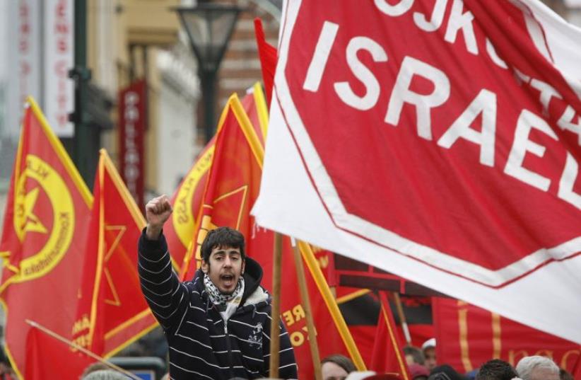 A protester chants slogans near a banner reading "Boycott Israel" during an anti-Israel march in Malmo (photo credit: REUTERS)