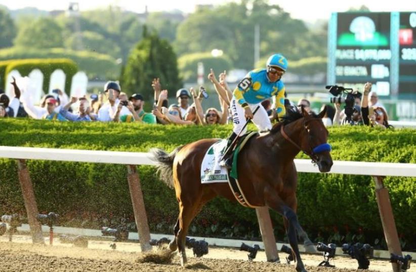 Victor Espinoza, celebrates atop American Pharoah #5, after winning the 147th running of the Belmont Stakes at Belmont Park (photo credit: AL BELLO / GETTY IMAGES NORTH AMERICA / AFP)