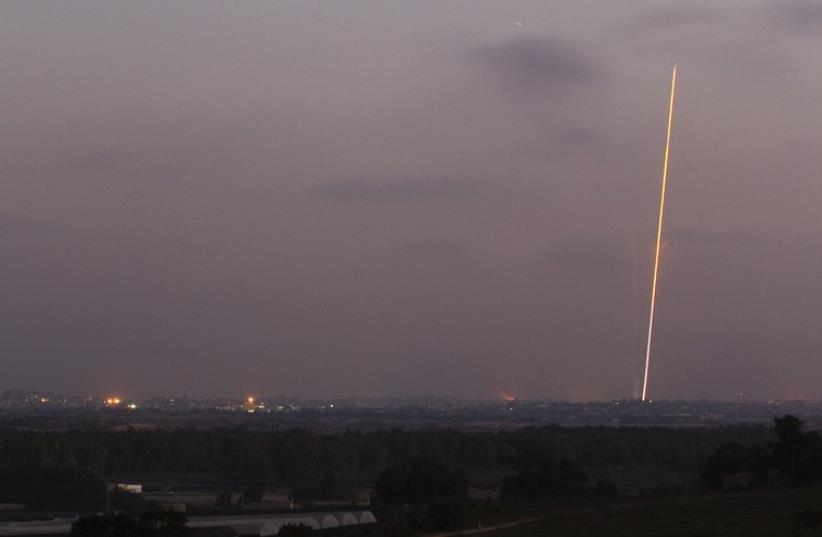 Light streak trail is seen as a rocket is launched from the northern Gaza Strip towards Israel July 29, 2014 (photo credit: REUTERS)
