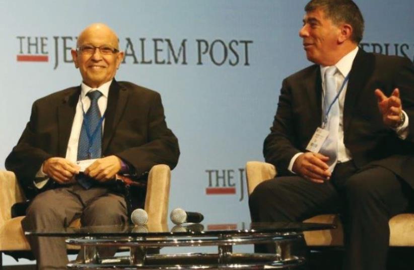 FORMER IDF chief of staff Gabi Ashkenazi gestures beside former Mossad chief Meir Dagan at 'The Jerusalem Post' Conference in New York. (photo credit: SIVAN FARAG)