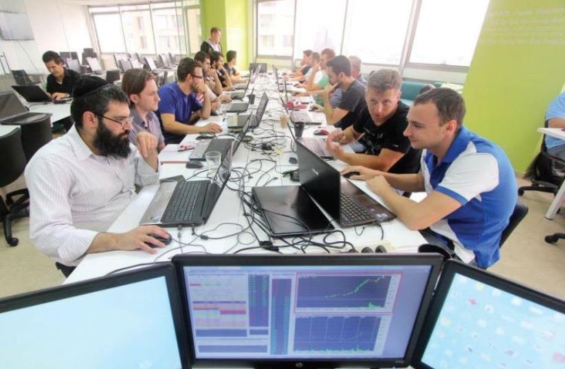 A haredi man trades stocks in Simple Trade’s shared workspace in Ramat Gan (photo credit: SIMPLE TRADE)