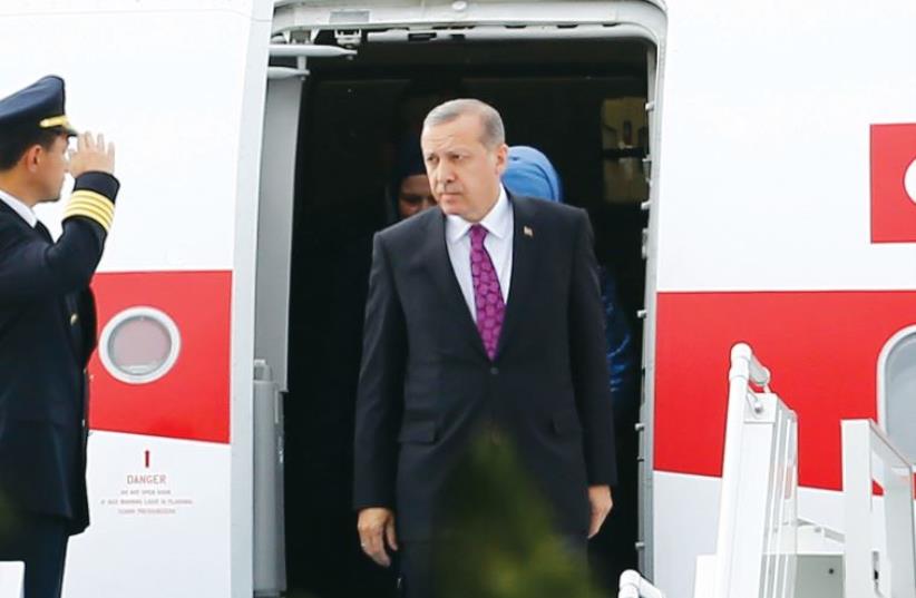 Turkish president Recep Tayyip Erdogan looks on after arriving in Ankara, on Tuesday. (photo credit: UMIT BEKTAS / REUTERS)