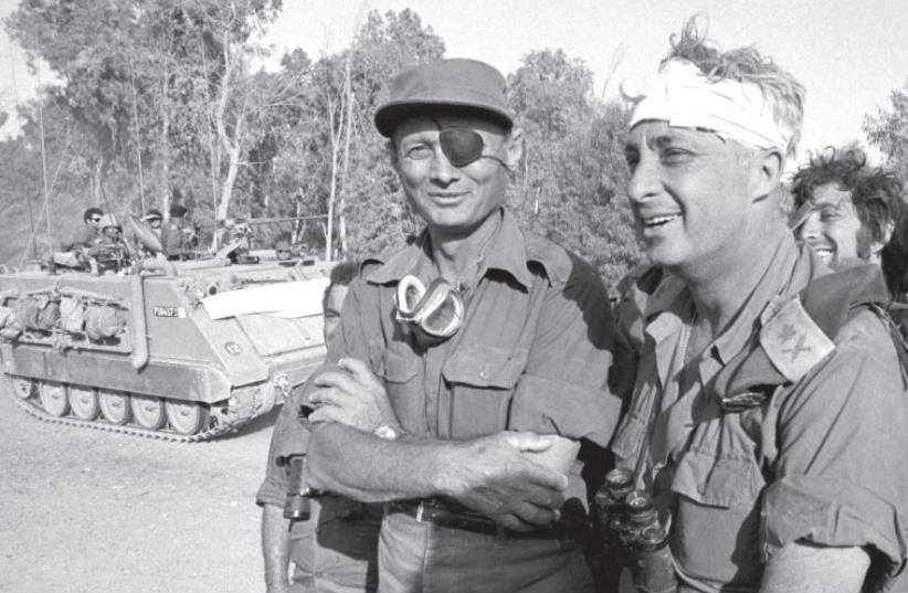 Moshe Dayan (left) and Ariel Sharon on the western side of the Suez Canal in October 1973. (photo credit: REUTERS)