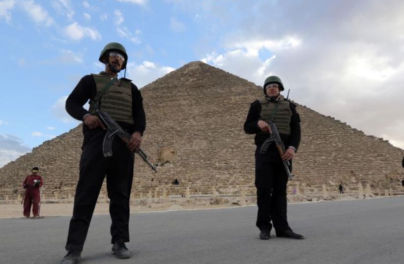Police officers guard the Great Pyramid of Cheops in Giza (photo credit: REUTERS)