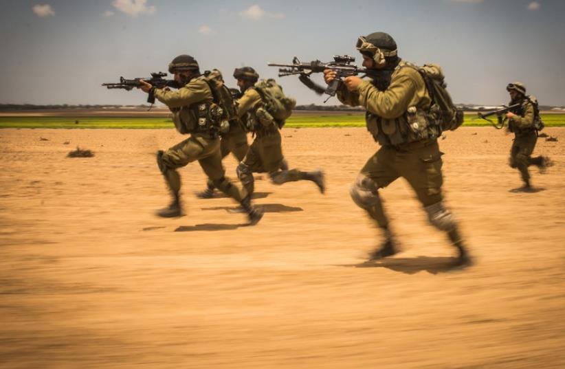 IDF soldiers storm a target during the ground incursion into Gaza (photo credit: IDF)