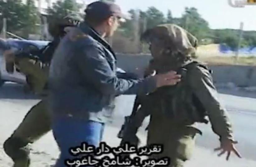 Footage of an IDF soldier in a violent confrontation with a Palestinian man in the West Bank (photo credit: screenshot)