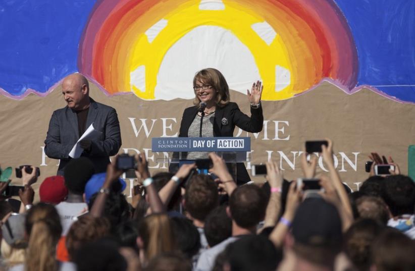 Former Navy pilot Mark Kelly and his wife, former Congresswoman Gabrielle Giffords, founders of Americans for Responsible Solutions, are pictured here in Phoenix, March 23 (photo credit: REUTERS)