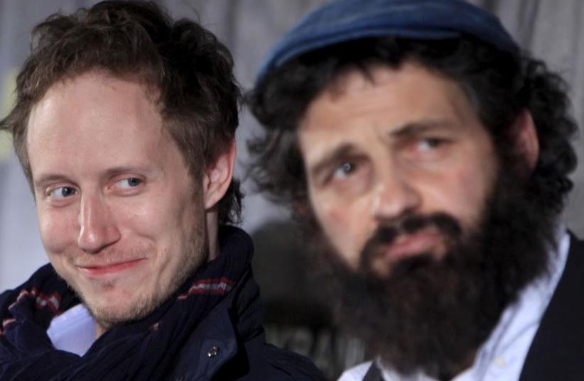 ‘Son of Saul’ director Lászlo Nemes (left) together with lead actor Géza Röhrig during a news conference in Budapest, May 28. (photo credit: BERNADETT SZABO / REUTERS)