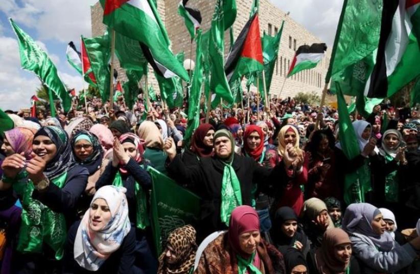 Palestinians supporting Hamas chant slogans during a rally celebrating Hamas student supporters winning the student council election at Birzeit University in Ramallah (photo credit: REUTERS)