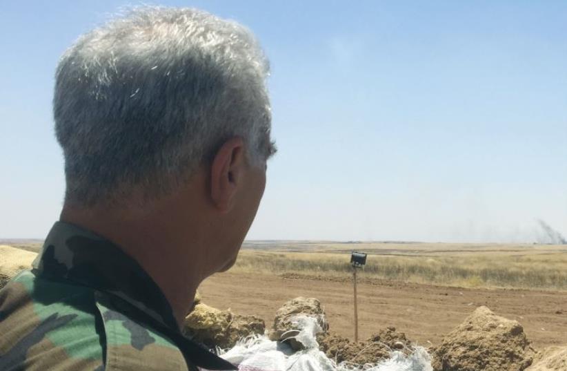 A Peshmerga soldier surveys the front line with Islamic State, at the Christian village of Talesskef, Iraqi-Kurdistan. (photo credit: SETH J. FRANTZMAN)