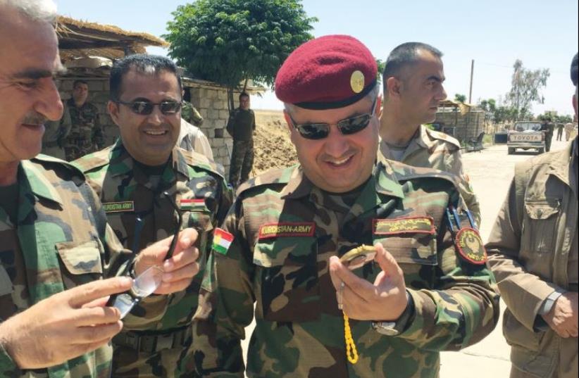 Gen. Tariq Harni smiles at a gift brought from Israel. (photo credit: SETH J. FRANTZMAN)
