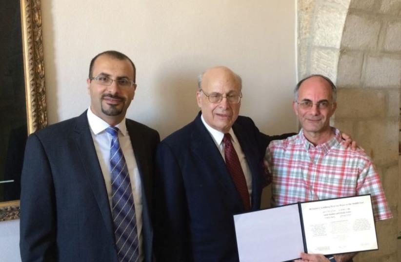 Victor J. Goldberg (center), poses yesterday at the Notre Dame Center in Jerusalem with Salah Alladin (left) and Yehuda Stolov, (photo credit: Courtesy)