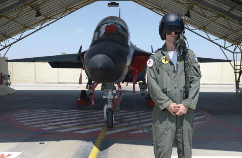 A member of the first Israel Air Force pilot course to train on the new Lavi jet trainer poses with the aircraft at an air force base recently. (photo credit: IDF SPOKESMAN’S UNIT)