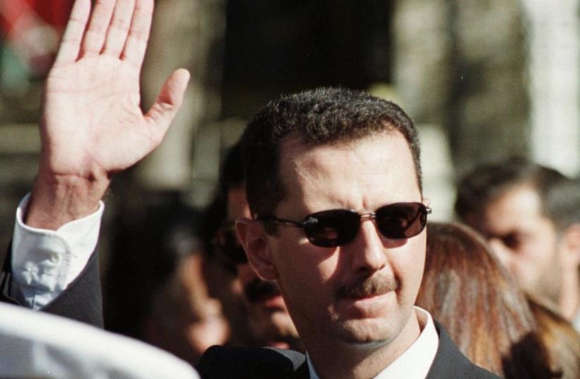 Syrian President Bashar Assad waves to supporters in Damascus (photo credit: REUTERS)